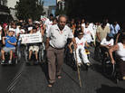 People with disabilities take part in a march against the government's new austerity measures in central Athens on Thursday. People with disabilities take part in a march against the government's new austerity measures in central Athens on Thursday.