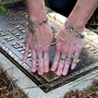 Lorie Miller affixes a QR code to her grandparents' gravestone. Miller and her husband are launching a business that will supply QR tags and maintain a website featuring the deceased. Lorie Miller affixes a QR code to her grandparents' gravestone. Miller and her husband are launching a business that will supply QR tags and maintain a website featuring the deceased.