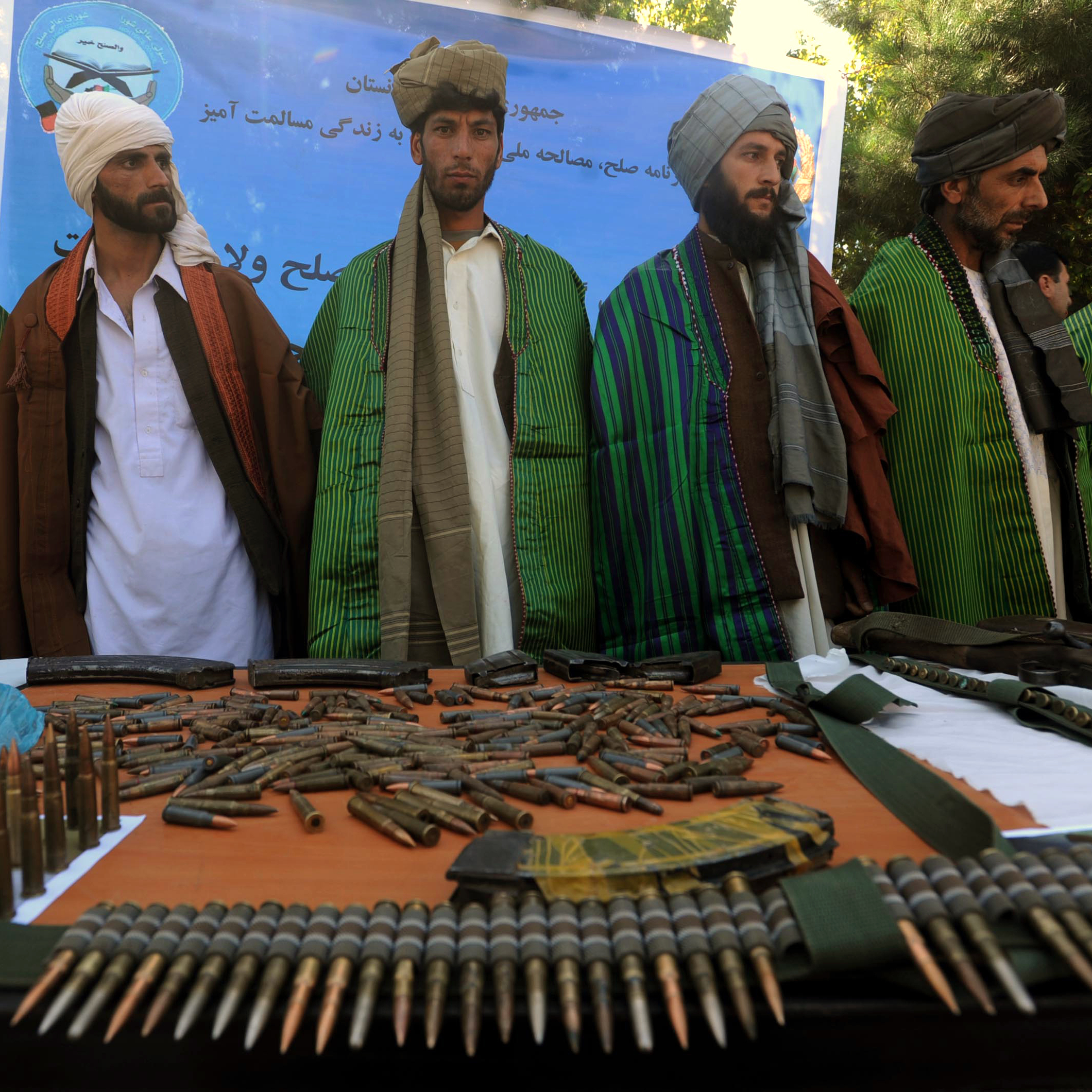 Former Taliban fighters display their weapons as they join Afghan government forces during a ceremony in Herat province on Sept. 18.