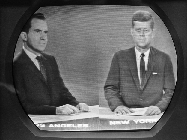 Vice President Richard Nixon listens as Sen. John F. Kennedy talks during their televised presidential race debate. This photo was made from a television screen in New York, Oct. 21, 1960.