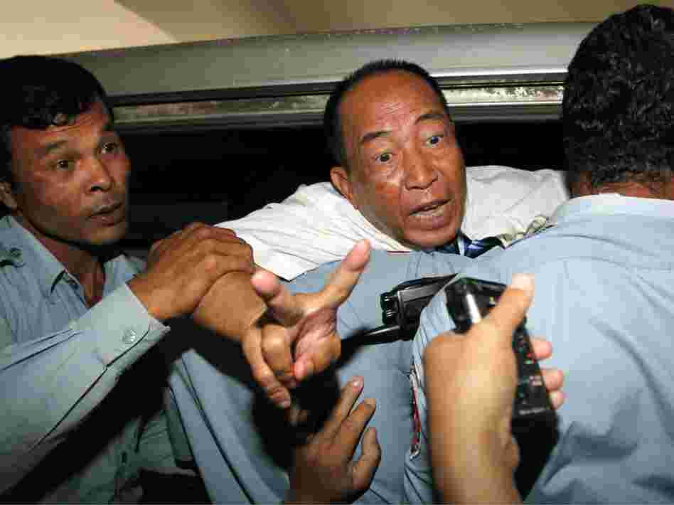 Supporters of Mam Sonando (shown here Monday after his conviction) say the pro-democracy activist drew the government's ire by trying to help farmers in eastern Kratie province protect their land. He also runs one of the few private broadcasters in the country that is critical of the government.