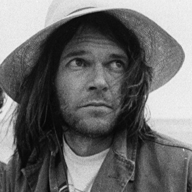 Neil Young (right) with book art director and friend Gary Burden, on the beach in Malibu, 1975.