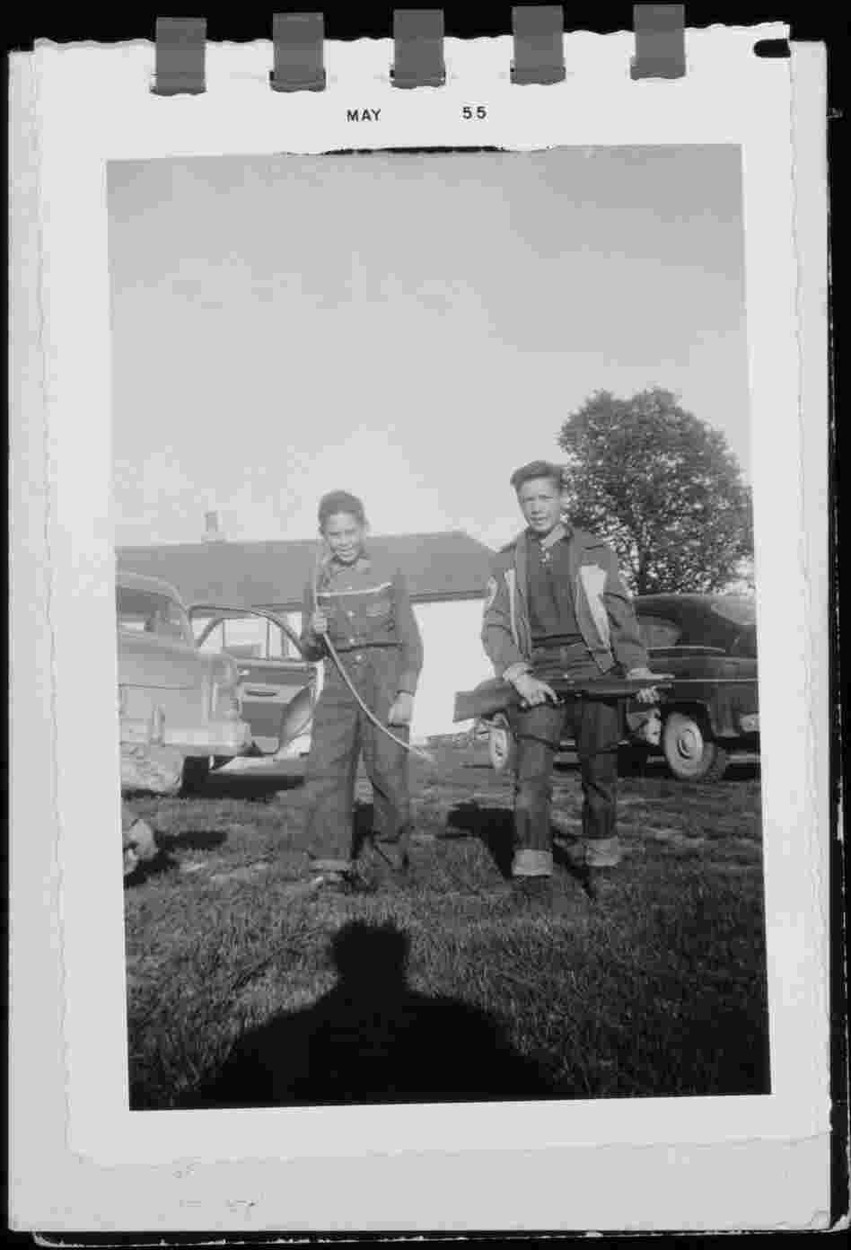 Neil Young's brother, Bob, holding a rifle, and Neil with a bow: Omemee, Ontario, 1955.