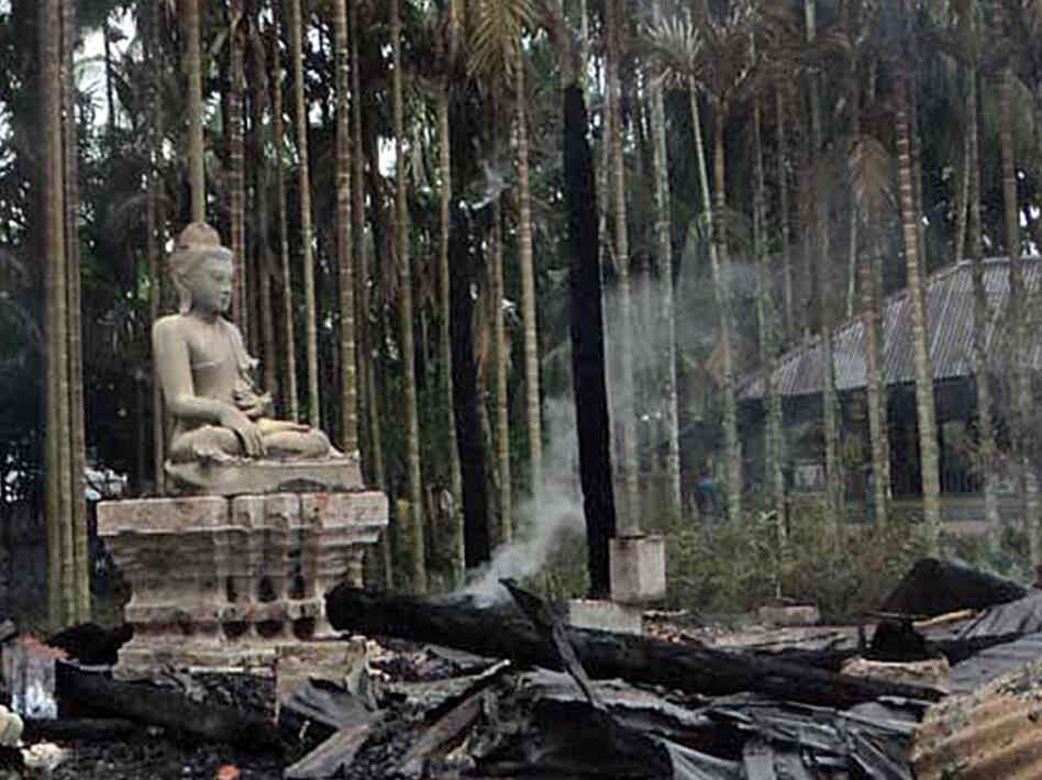 A statue of Lord Buddha is left standing amidst the torched ruins of the Lal Ching Buddhist temple at Ramu, Bangladesh. Thousands of rioters torched Buddhist temples and homes in southeastern Bangladesh Sunday over a photo posted on Facebook deemed offensive to Islam, in a rare attack against the community.