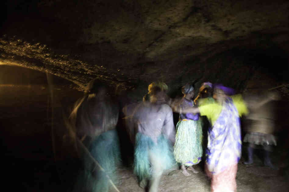 This sacred cave housed the Batwa king and was the main venue for celebrations. A choir in the darkness sings a song of sadness about how the Batwa were driven from the forest, and how much they miss it.