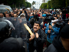 A Tunisian protester holds a baguette while taking to riot police in January 2011. A Tunisian protester holds a baguette while taking to riot police in January 2011.
