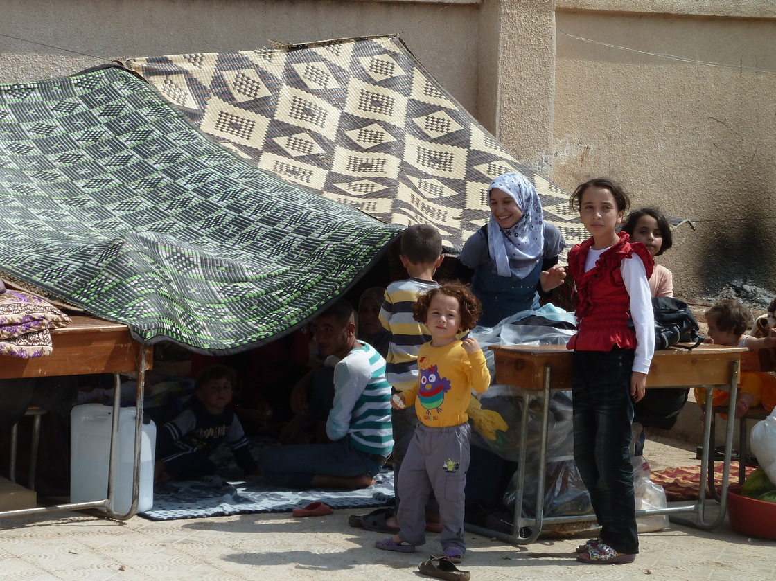 Syrian refugees live under makeshift tents in the grounds of a school in Atme, a village controlled by the Free Syrian Army.