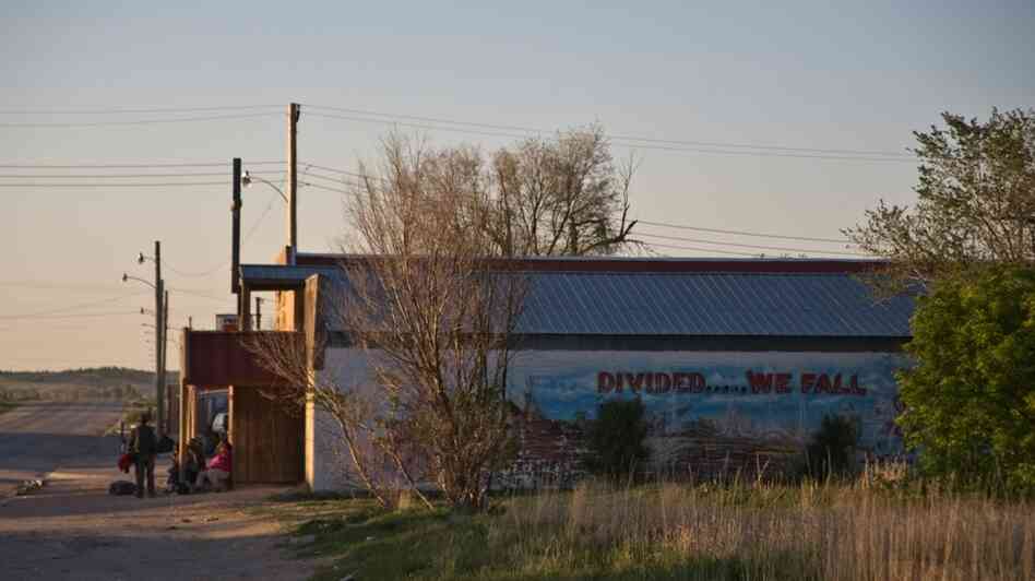 On the south side of Whiteclay, Neb., a crowd gathers outside one of the town's four liquor stores. On the south side of Whiteclay, Neb., a crowd gathers outside one of the town's four liquor stores.