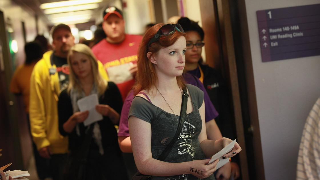 Students wait in line to vote last Friday on the campus of the University of Northern Iowa in Cedar Falls, a day after the swing state began in-person early voting.