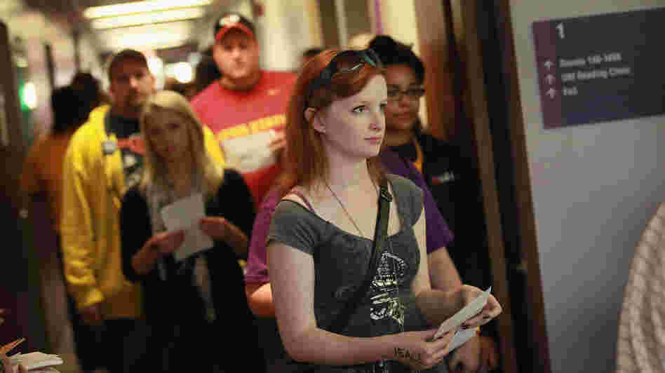 Students wait in line to vote last Friday on the campus of the University of Northern Iowa in Cedar Falls, a day after the swing state began in-person early voting.