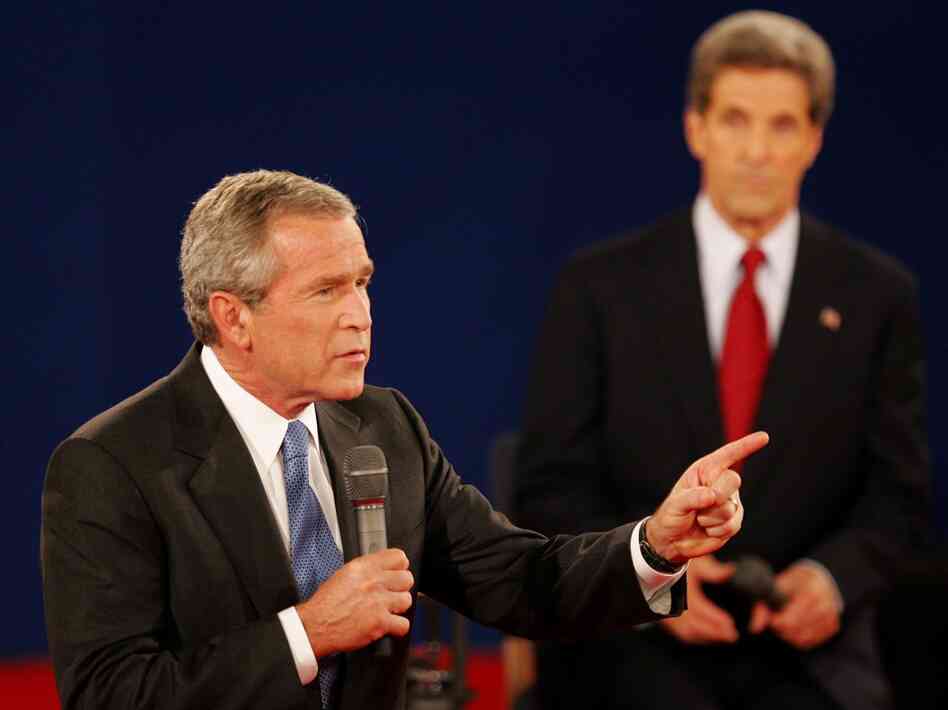 In a 2004 debate in St. Louis, President Bush answers a question as his opponent, Sen. John Kerry, listens. Both candidates used a number of "pivots" in their debates.