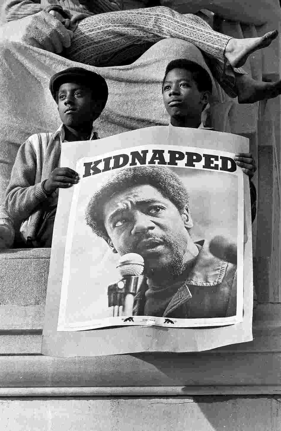 Two young men are shown at a May 1, 1970, rally in support of Black Panther Party Chairman Bobby Seale and other Panthers in New Haven, Conn., who were being tried for the murder of a fellow Panther who confessed to being a police informant.