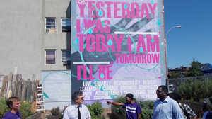 The Brownsville NeON probation office partnered with the public arts group Groundswell to establish a community garden in Brownsville. Local probationers designed and created the garden and mural. Here, the commissioner of the New York City Department of Probation, Vincent Schiraldi (second from left), meets with local advocates involved in the project.