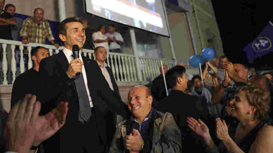 Georgian billionaire and opposition leader Bidzina Ivanishvili (left) reacts with supporters at his office on Monday. Ivanishvili defeated Georgian President Mikheil Saakashvili in the election, clearing the way for a new government. Georgian billionaire and opposition leader Bidzina Ivanishvili (left) reacts with supporters at his office on Monday. Ivanishvili defeated Georgian President Mikheil Saakashvili in the election, clearing the way for a new government.