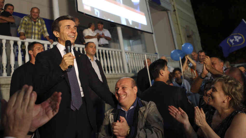 Georgian billionaire and opposition leader Bidzina Ivanishvili (left) reacts with supporters at his office on Monday. Ivanishvili defeated Georgian President Mikheil Saakashvili in the election, clearing the way for a new government. Georgian billionaire and opposition leader Bidzina Ivanishvili (left) reacts with supporters at his office on Monday. Ivanishvili defeated Georgian President Mikheil Saakashvili in the election, clearing the way for a new government.