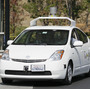 California Gov. Jerry Brown (front left) rides in a driverless car to a bill signing at Google headquarters in Mountain View, Calif., on Sept. 25.