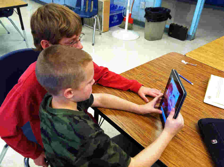In Durham, N.H., Oyster River Middle School seventh-graders Patrick Beary and Morgan Bernier play with StoryKit, a free app that helps middle-schoolers put together simple presentations, and elementary students make storybooks.