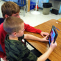 In Durham, N.H., Oyster River Middle School seventh-graders Patrick Beary and Morgan Bernier play with StoryKit, a free app that helps middle-schoolers put together simple presentations, and elementary students make storybooks.