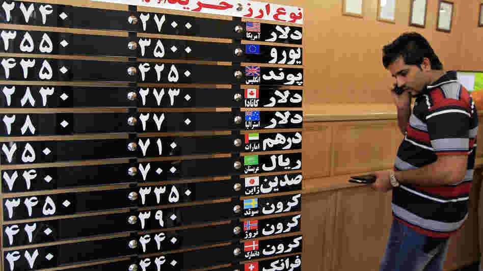 An Iranian man checks the rates of foreign currencies at a currency exchange bureau in central Tehran on Sept. 29. The Iranian currency lost nearly one-third of its value in a day over the weekend. An Iranian man checks the rates of foreign currencies at a currency exchange bureau in central Tehran on Sept. 29. The Iranian currency lost nearly one-third of its value in a day over the weekend.