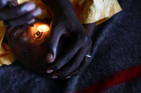 A health worker looks for signs of vision in the eyes of Yusuf Labbo. Severe lead poisoning has left the 5-year-old boy blind. He weighs just 22 pounds, can't speak or walk and spends most of his days clutched in his mother's arms.