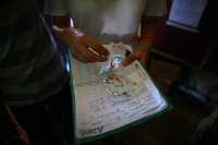 Susan Lake, a nurse for Doctors Without Borders, goes over the list of pills for one of her patients at the clinic in Dareta. More than 400 kids have already died from lead poisoning, while thousands of others are stunted physically and mentally.