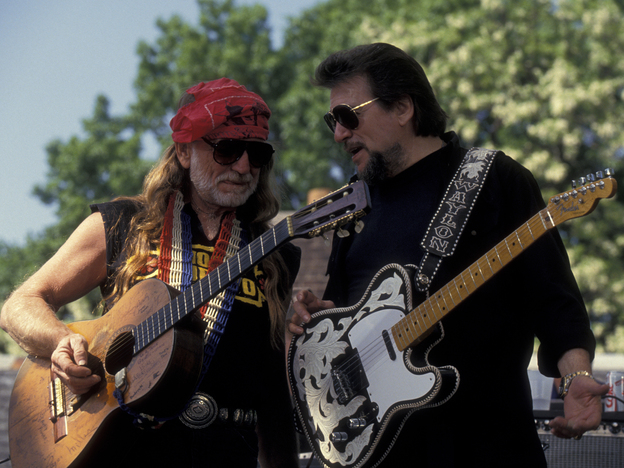 Willie Nelson (left) and Waylon Jennings, members of the country supergroup The Highwaymen, perform at a concert in Central Park in 1993.