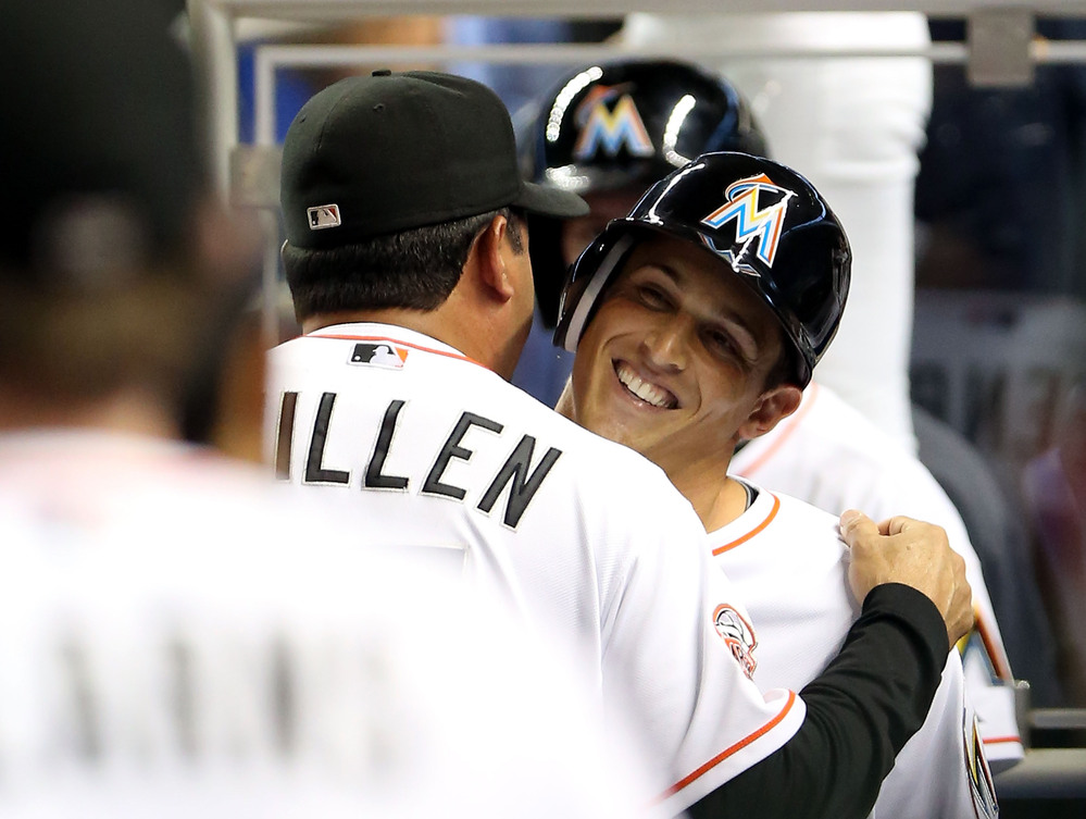 Adam Greenberg of the Miami Marlins hugs manager Ozzie Guillen after striking out against the New York Mets.