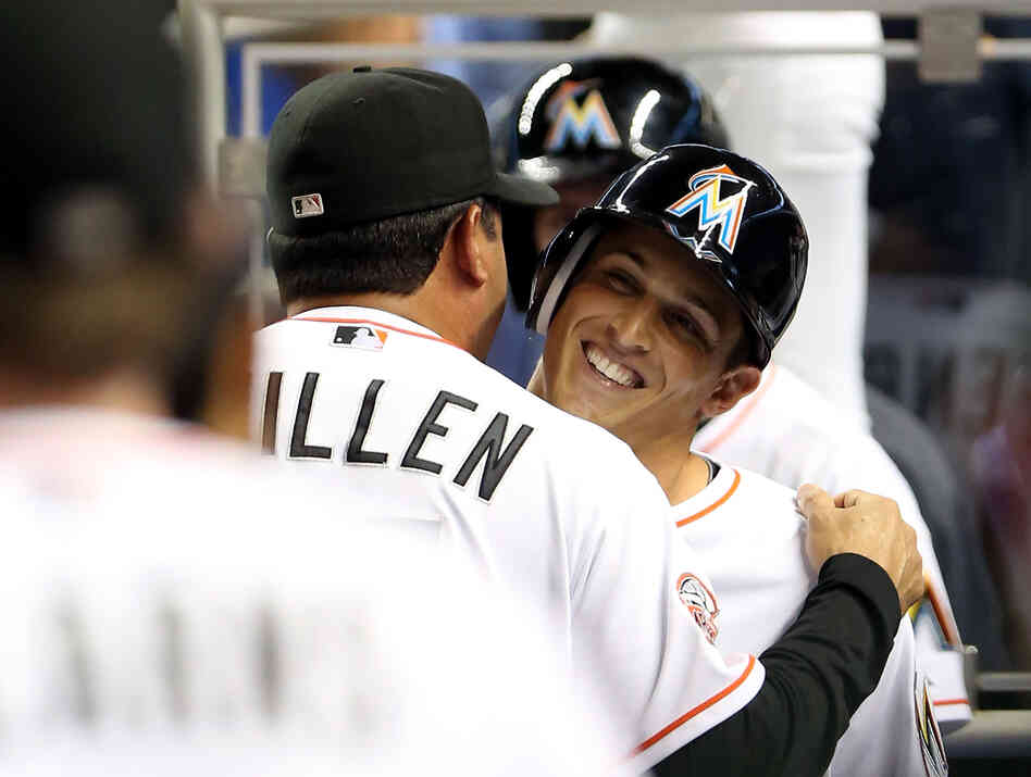 Adam Greenberg of the Miami Marlins hugs manager Ozzie Guillen after striking out against the New York Mets.