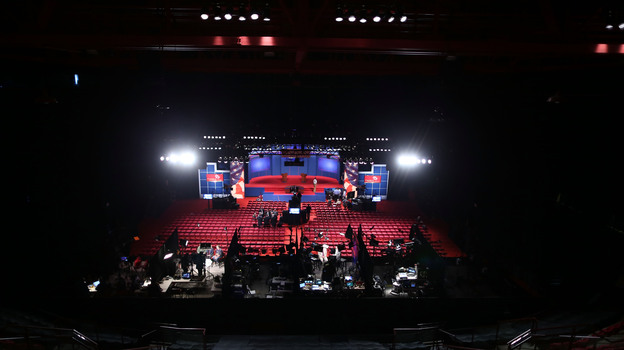 Workers prepare Wednesday for the presidential debate at the University of Denver. Experts differ over whether even a televised debate is a good forum for sharing very specific details about policy proposals.