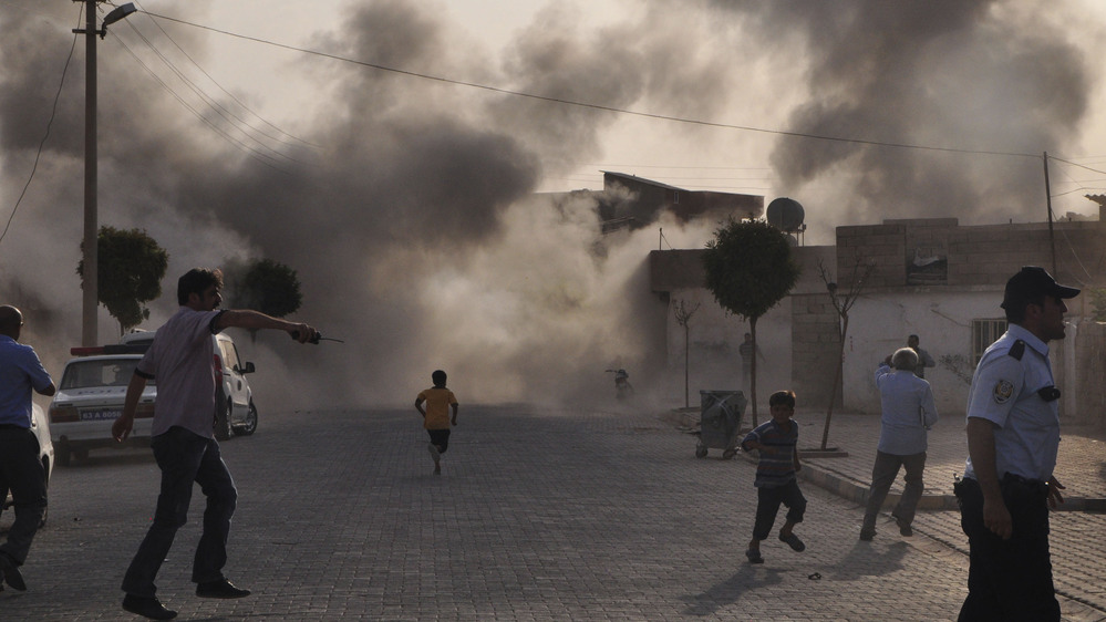 Smoke rises after artillery fire  from nearby Syria hits the Turkish border town of  Akcakale. Turkey said five of its citizens were killed and that it responded by firing on targets in northern Syria. The episode raised tensions on the already volatile border region.