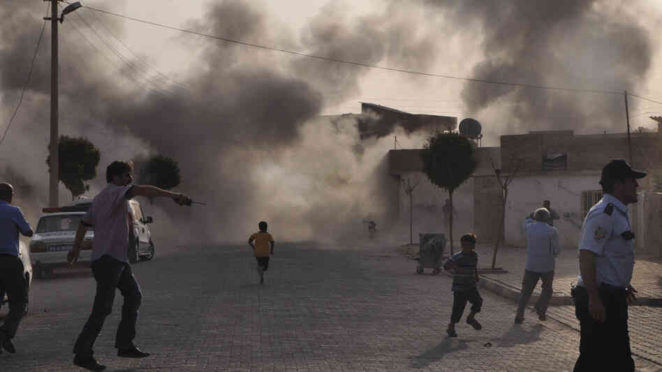 Smoke rises after artillery fire  from nearby Syria hits the Turkish border town of  Akcakale. Turkey said five of its citizens were killed and that it responded by firing on targets in northern Syria. The episode raised tensions on the already volatile border region.