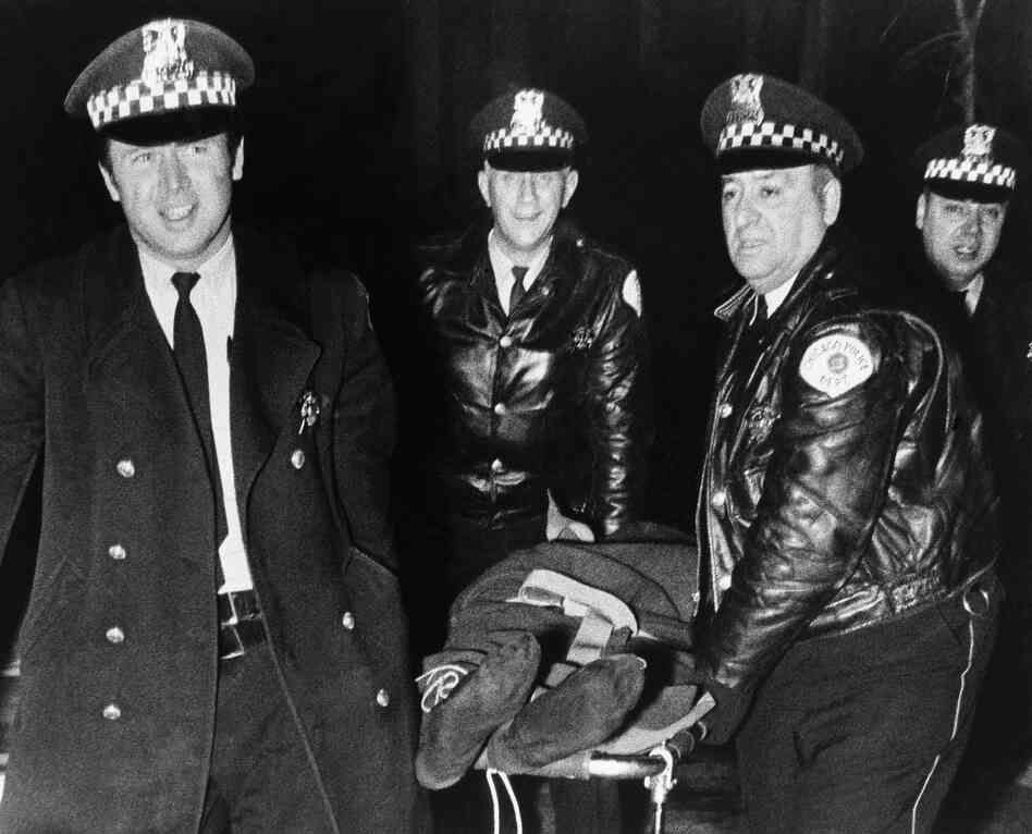 Chicago police remove the body of Fred Hampton, leader of the Illinois Black Panther Party, who was slain in a gunbattle with police in Chicago on Dec. 4, 1969, when police tried to search the group's office. Hampton was one of several Black Panthers who were killed in shootouts with police.