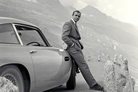 Sean Connery relaxes on the bumper of his Aston Martin DB5 during the filming of location scenes for Goldfinger in the Swiss Alps in 1964. Sean Connery relaxes on the bumper of his Aston Martin DB5 during the filming of location scenes for Goldfinger in the Swiss Alps in 1964.