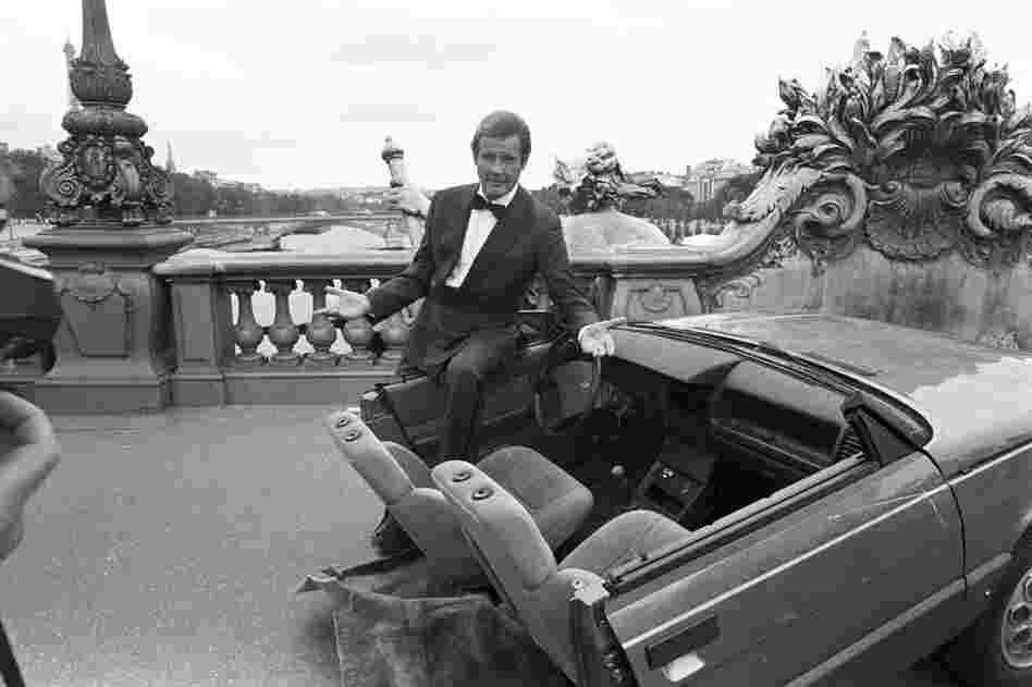 Roger Moore with half a car during the filming of A View to a Kill in Paris, 1984. Moore was part of the iconic series for more than a decade, playing Bond in seven consecutive films.