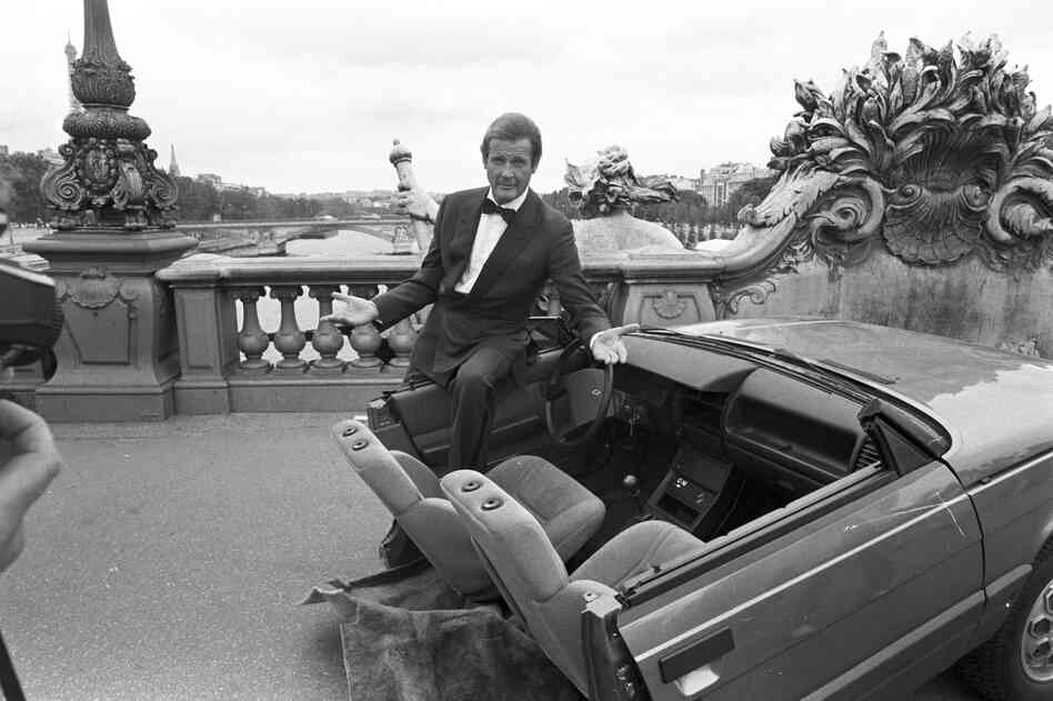 Roger Moore with half a car during the filming of A View to a Kill in Paris, 1984. Moore was part of the iconic series for more than a decade, playing Bond in seven consecutive films.