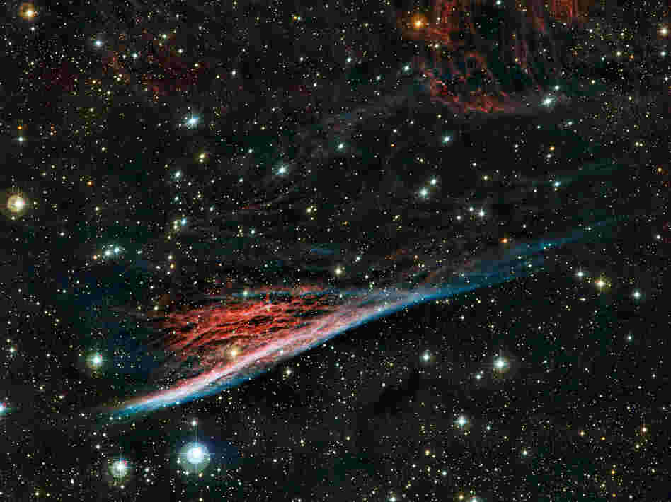 Just the tiniest slice of what's out there: the Pencil Nebula is pictured in an image from the European Southern Observatory's La Silla facility in Chile. This peculiar cloud of glowing gas is part of a huge ring of wreckage left over after a supernova explosion that took place about 11,000 years ago. Just the tiniest slice of what's out there: the Pencil Nebula is pictured in an image from the European Southern Observatory's La Silla facility in Chile. This peculiar cloud of glowing gas is part of a huge ring of wreckage left over after a supernova explosion that took place about 11,000 years ago.