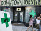 Pedestrians pass a medical marijuana dispensary in the Echo Park area of Los Angeles on July 24, 2012.
