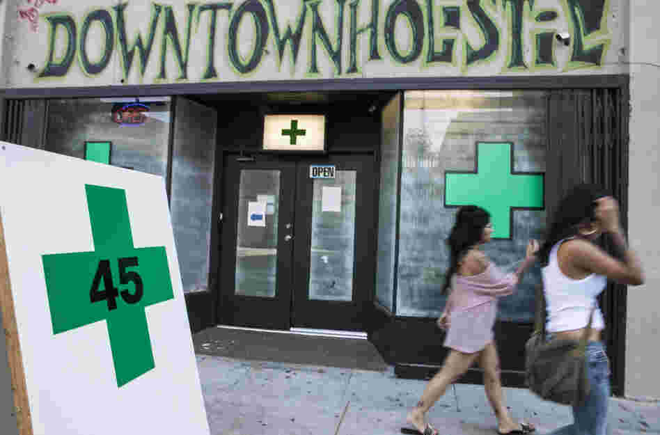 Pedestrians pass a medical marijuana dispensary in the Echo Park area of Los Angeles on July 24, 2012.