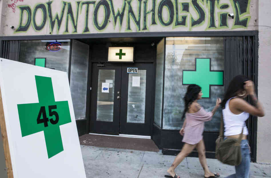 Pedestrians pass a medical marijuana dispensary in the Echo Park area of Los Angeles on July 24, 2012.