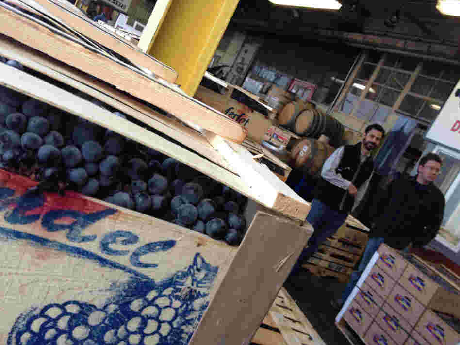 Customers at a Hartford produce market, choosing grapes to turn into homemade wine.