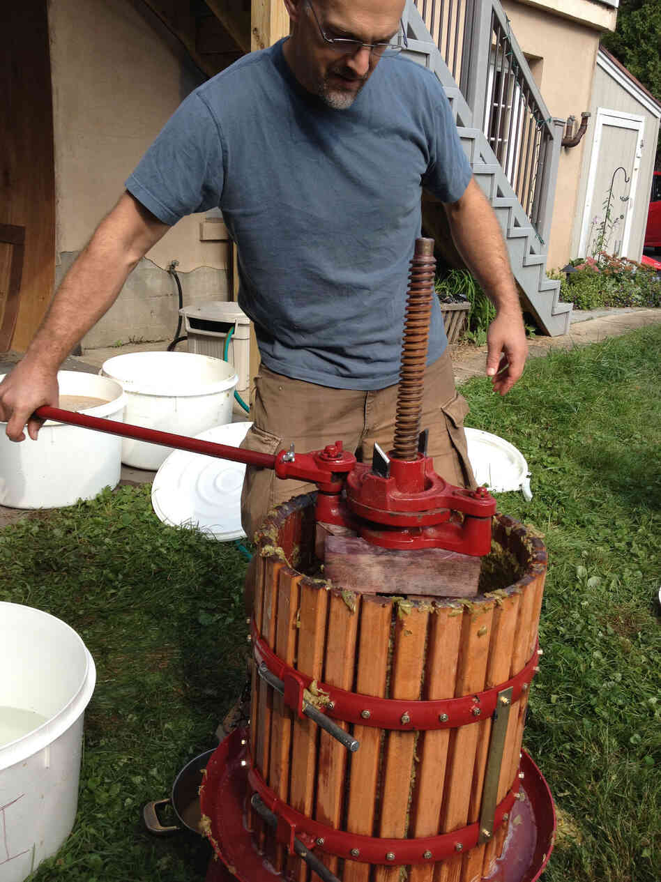 DIY winemaker John Virtue presses the grapes in a Middletown, Conn., backyard.