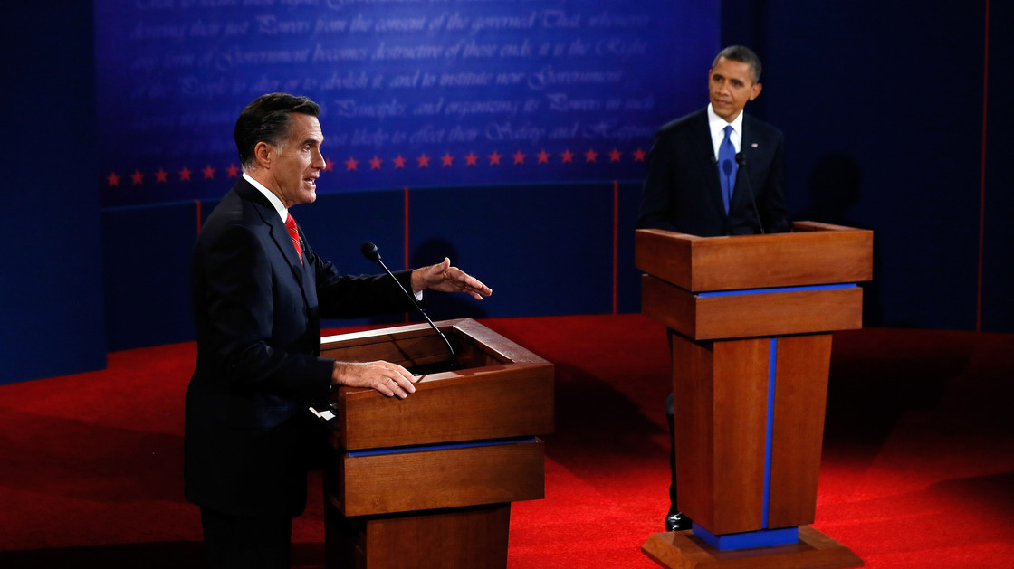Mitt Romney makes his point as President Obama listens during Wednesday's debate in Denver.