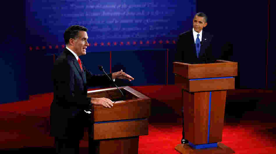 Mitt Romney makes his point as President Obama listens during Wednesday's debate in Denver.
