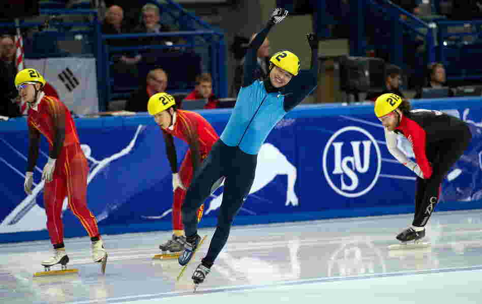 Simon Cho (center) celebrates after beating China's Liang Wenhao and Liu Xianwei and Canada's Olivier Jean (right) in the men's 500-meter final at the 2011 World Short Track Speed Skating Championships in England.
