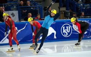 Simon Cho (center) celebrates after beating China's Liang Wenhao and Liu Xianwei and Canada's Olivier Jean (right) in the men's 500-meter final at the 2011 World Short Track Speed Skating Championships in England.