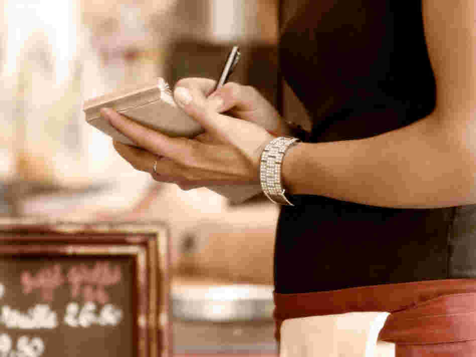 Waitress writes down an order.
