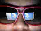 Does he need to watch what he likes? Facebook's logo is reflected in the glasses of a student in Manila.