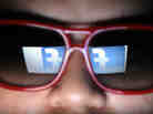 Does he need to watch what he likes? Facebook's logo is reflected in the glasses of a student in Manila.