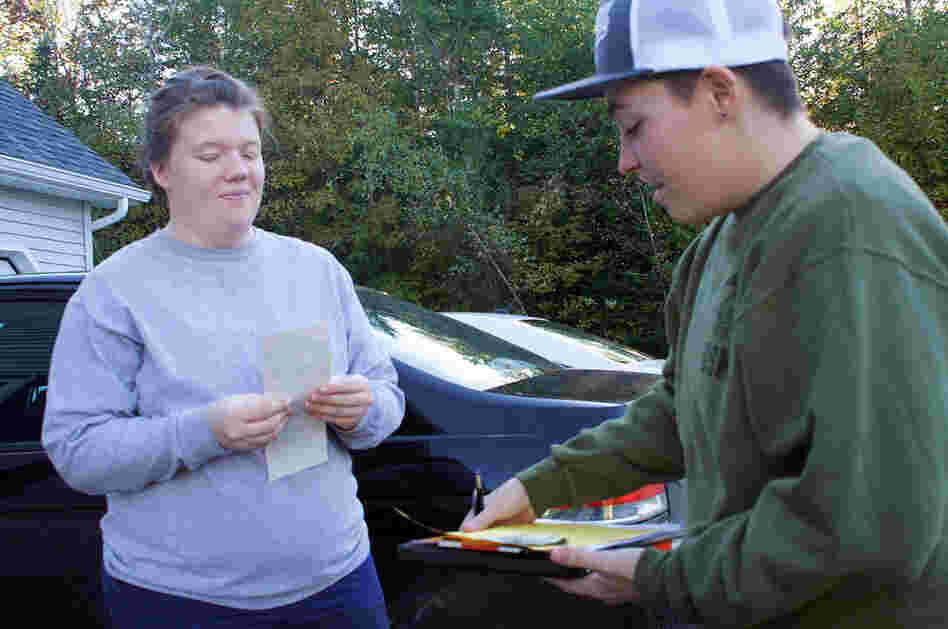 Tucker of Equality Maine talks with a supporter in Dexter, Maine, who bought a bumper sticker.