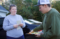 Tucker of Equality Maine talks with a supporter in Dexter, Maine, who bought a bumper sticker.